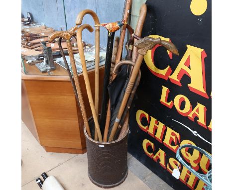 A collection of walking sticks, in Vintage stand 