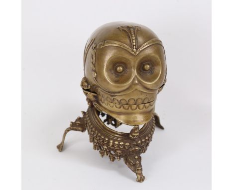 A Tibetan Buddhist cast-brass ritual Kapala/skull cup, with vajra and tripod base, overall height 20cm 