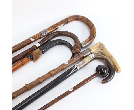 A group of Vintage walking sticks and canes, including silver collars 