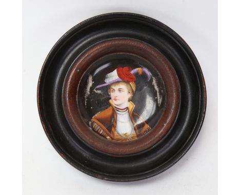 A miniature hand painted porcelain panel, depicting head and shoulders portrait of a lady, framed, overall diameter 16.5cm 