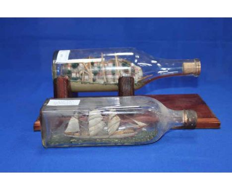TWO VINTAGE MODEL SHIPS IN BOTTLES
one in a square sided bottle of a ship at sea, the other of a ship at port with relief of 