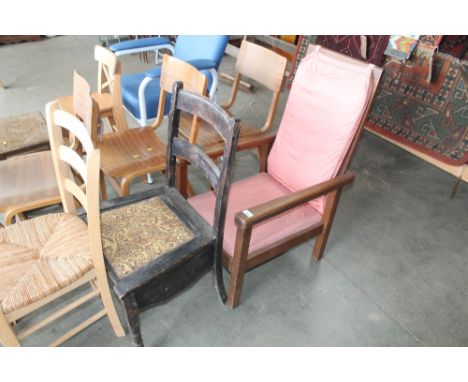 An oak fireside chair and a commode chair