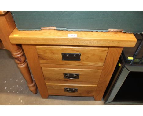 A modern light oak bedside chest fitted three drawers AF