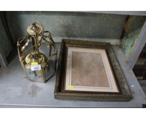 A gilt picture frame together with another picture frame and a brass ceiling light