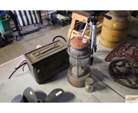 A metal ammo tin; a tilly lamp with burner