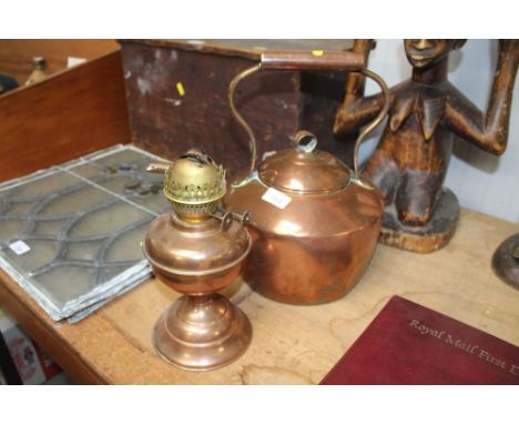 A copper kettle together with a copper oil lamp