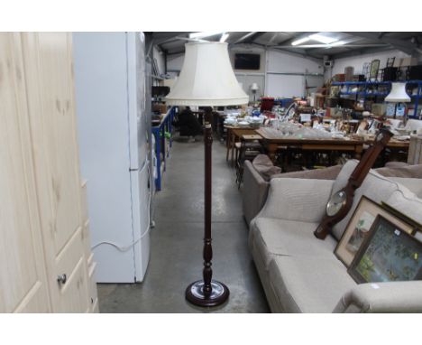 A reproduction mahogany standard lamp