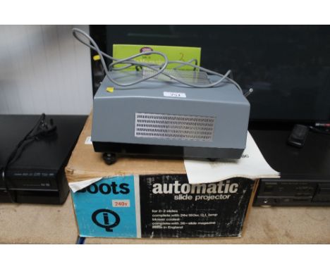 A Boots automatic slide projector with various slide magazines, sold as a collectors item