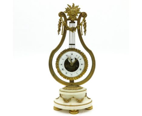 Last quarter of the 18th century, on white marble base, round movable pendulum with enamel dial with second hand.  A similar 