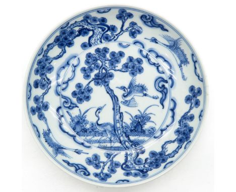 Blue and white decor of cranes, marked on back with double ring and 6 characters, 20 cm. in diameter, restoration on edge.