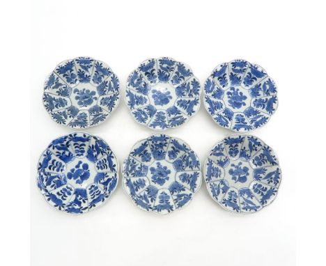 Scalloped edge, blue and white floral decor, marked with ring and symbol on bottom, 15 cm. in diameter, chip on standring.