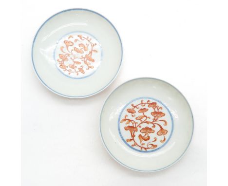 Orange floral decor with blue trim, marked with double ring and 6 characters, 12 cm. in diameter.