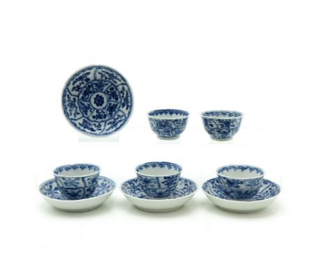 Blue and white decor, including 4 saucers and 5 cups, saucers are 8 cm. in diameter, some with chip and hairline. 