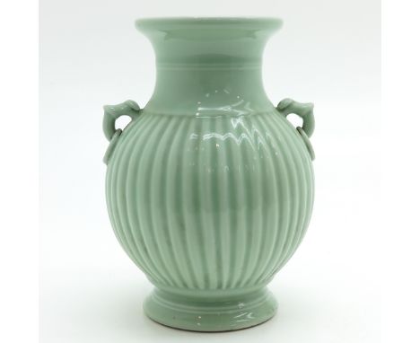 Celadon, ribbed decor with bamboo and ring handles, marked on bottom with seal mark, 27 cm. tall.