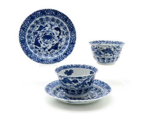 Blue decor of flowers and sea creatures, marked with double ring and flower, saucer is 13 cm. in diameter, chip and hairline.