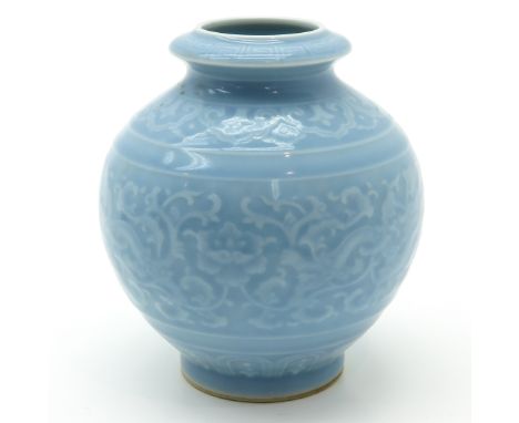 Light blue glaze with raised decor of flowers and dragons, marked on bottom with seal mark, 16 cm. tall.
