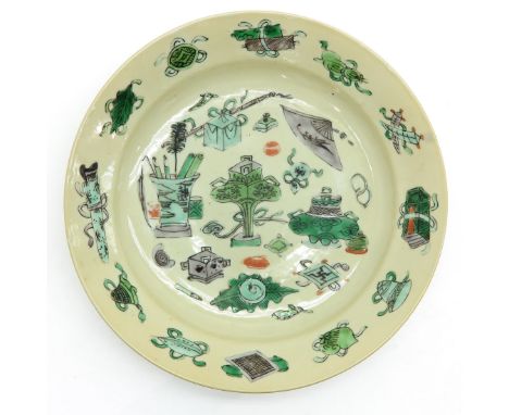 Cream background with decor of Chinese valuables, marked on back with double ring and rabbit, 21 cm. in diameter, small chip.