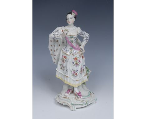 A Derby Patch Mark figure, The Ranelagh Dancer, she stands with flowers in her hair, wearing a gown and cloak, in a mirror po