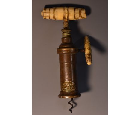 A 19th century corkscrew, Dowler Patent, turned barrel-shaped bone handle and key, canted rectangular patent cartouche cast i