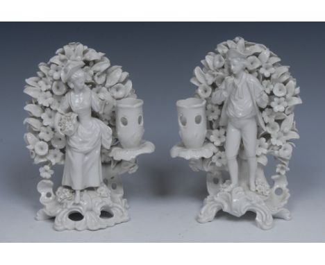 A pair of 19th century hard paste smokey glazed blanc de chine figural candlestick, in the manner of Plymouth, of a man and l