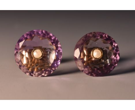 A pair of amethyst and seed pearl earrings, each with dished circular disc, with faceted rims and seed pearl centre, unmarked