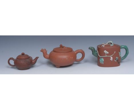 A Yixing globular teapot, incised with characters, shaped spout, the cover with lizard finial, 11cm high, another, rounded re