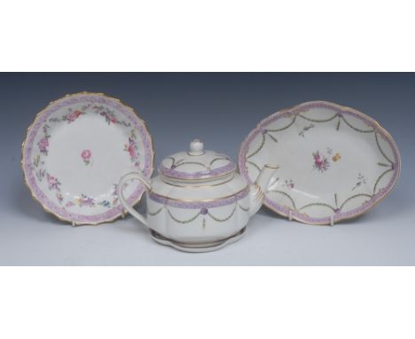 A Derby shaped oval plate, painted with flower sprig, with husk swags and roundels, banded in lilac with scrolls, gilt dentil