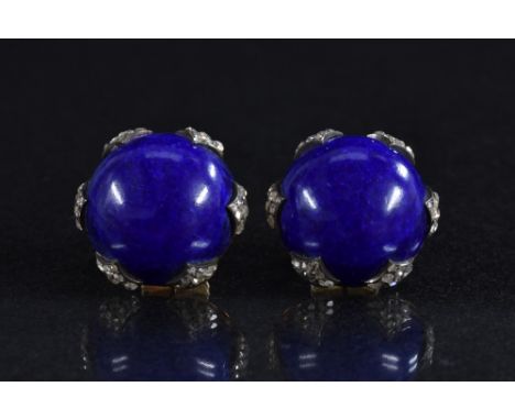 A pair of blue hard stone cabochon and diamond earrings, central cobalt blue circular stone cabochon within a six section dia