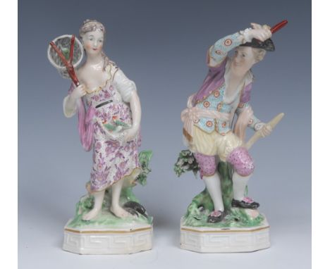 A Derby Patch Mark figure, Allegorical of Water, she stands bare footed in a puce flower scroll dress, securing her catch of 
