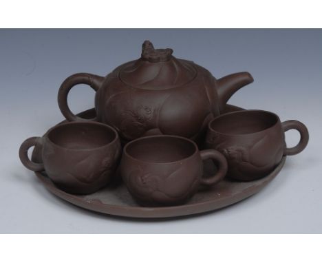 A Chinese Yixing globular teapot and cover, in relief with dragons and clouds, the domed cover with dragon, 12cm high;  three