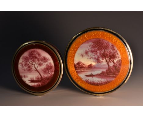 An early 20th century silver and enamel circular rouge box, hinged cover decorated in tones of puce with a landscape, , enclo