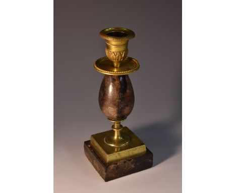 A Derbyshire Blue John and ormolu candlestick, egg-shaped column, reeded nozzles with lotus border, beaded circular drip pans