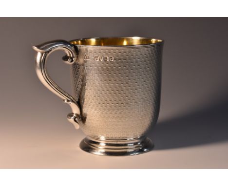 A Victorian silver Christening mug, engine turned and centred by a circular cartouche, scroll-capped handle, skirted base, gi