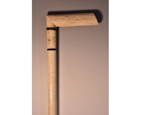 An early 19th century sailor's scrimshaw whalebone walking stick, flattened crook handle, silver and hardwood collars, 92cm l