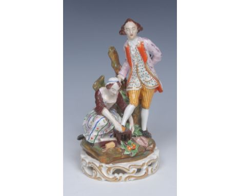A Bloor Derby figure group, Shoe-Black, a gallant stands, wearing colourful clothes, his right foot resting on a foot-stool, 