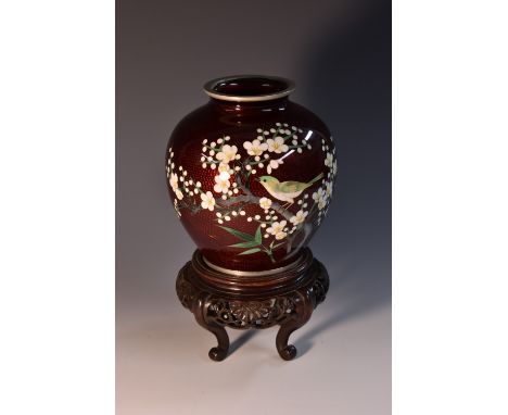 A Japanese cloisonné enamel ovoid vase, decorated in colourful polychrome with a finch on a branch of cherry blossom, garnet 