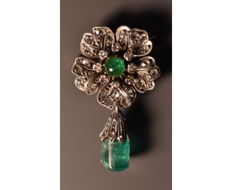 An emerald and diamond flower brooch, set with a central cabochon emerald within diamond encrusted surround above a conformin