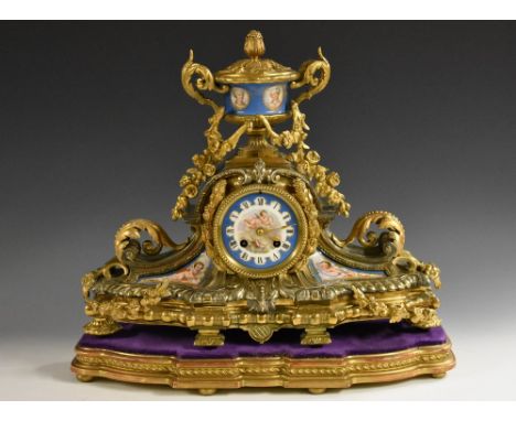 A French gilt metal and porcelain mantel clock, 8cm diam, Roman numerals, twin winding holes, eight day movement striking on 