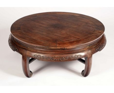 ***IN SALEROOM TWO***A Chinese hardwood low circular occasional table, shaped frieze carved in relief, scroll feet, 36cm high