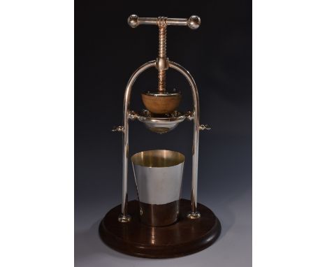 An early 20th century E.P.N.S and oak table top lemon squeezer, screw-action mechanism, circular base, retailed by H J Linton