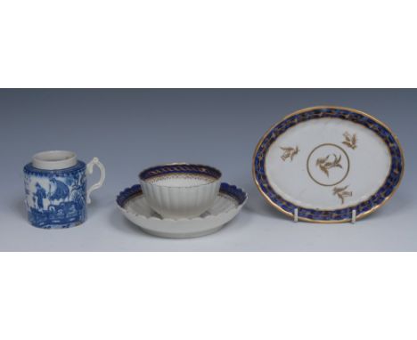 A Salopian  fluted tea bowl and saucer, banded in cobalt blue, applied in gilt with strapwork, S mark, c.1780;  a Caughley cy