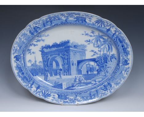 A Spode North African Square Tower pattern oval meat plate,  printed in tones of blue with figures by a town gate, the border