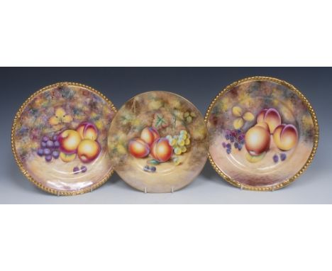A Royal Worcester circular plate, painted by K. Smith, with grapes, peaches and blackberries on a mossy bank, 23cm diam, prin