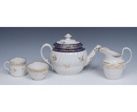 A Coalport spirally fluted teapot and cover, in gilt with scatted thistles, banded in cobalt blue, 18cm high, c.1800; a simil