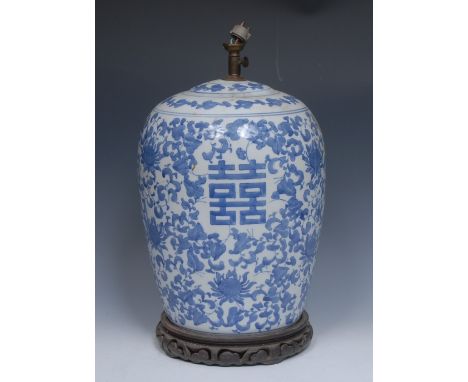 A Chinese ovoid blue and white table lamp, decorated with scrolling lotus and characters, 42cm high, hardwood base