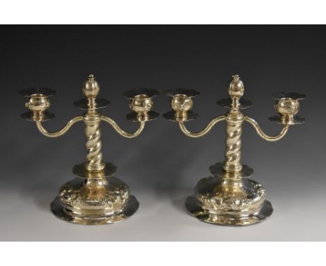 A pair of Swedish silver two-light candelabra, in the 18th century taste, wavy sconces and drip pans, bud finials, twisted pi