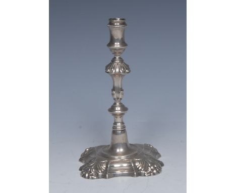 A George III cast silver taper candlestick, reel shaped sconce, knopped stem, shaped square base, 13cm high, John Ormell c.18