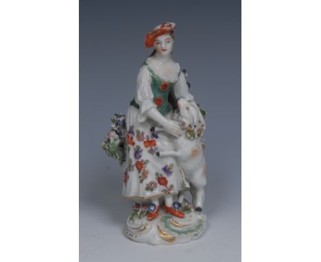 A Derby Patch Mark figure, of a Shepherdess, she standing wearing a green bodice and floral dress, with a sheep wearing a flo