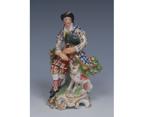 A Derby Patch Mark figure, The Bagpiper, wearing soft hat, fancy jacket and breeches, a dog at his side, pierced scroll base,