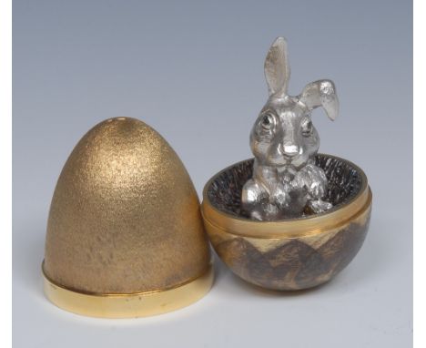 Stuart Devlin (Bn.1931) - an Elizabeth II parcel-gilt silver Surprise Egg, the interior with comical rabbit, textured finish,